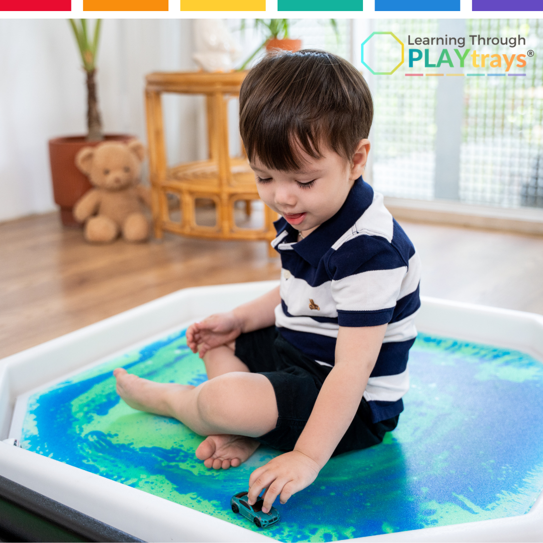 Child playing with a toy on a PLAYtrays product in a home setting