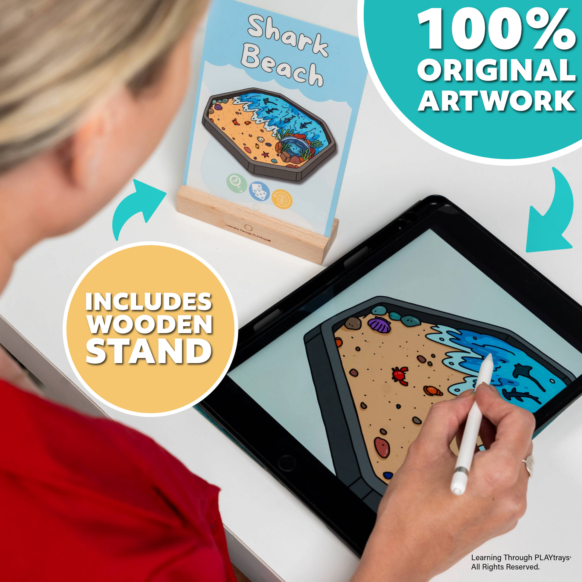 Person using stylus on digital tablet to create sensory play Shark Beach card artwork with wooden stand displayed nearby, showcasing 100% original illustrations.