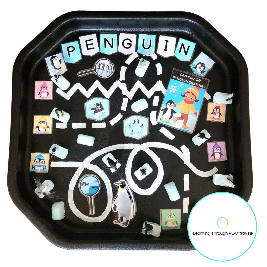 Educational play  tray with penguin-themed activities and cards on a white background.